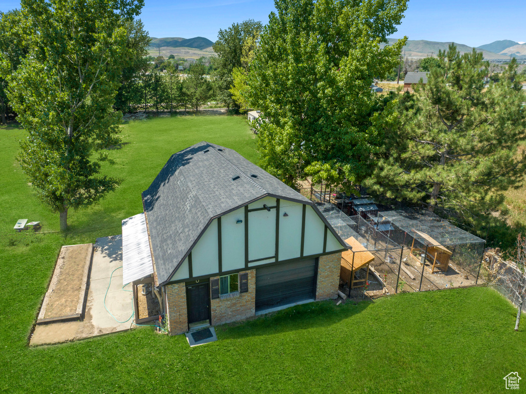 View of poultry coop featuring a lawn and a mountain view