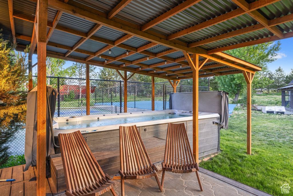View of patio with a hot tub