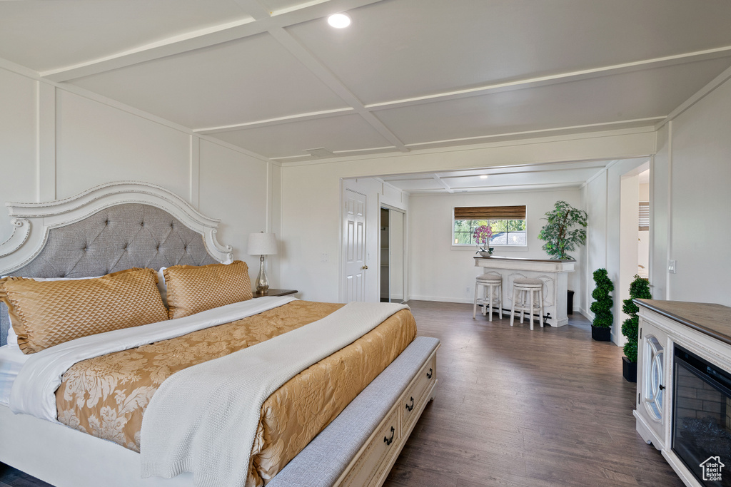 Bedroom with dark wood-style flooring and baseboards
