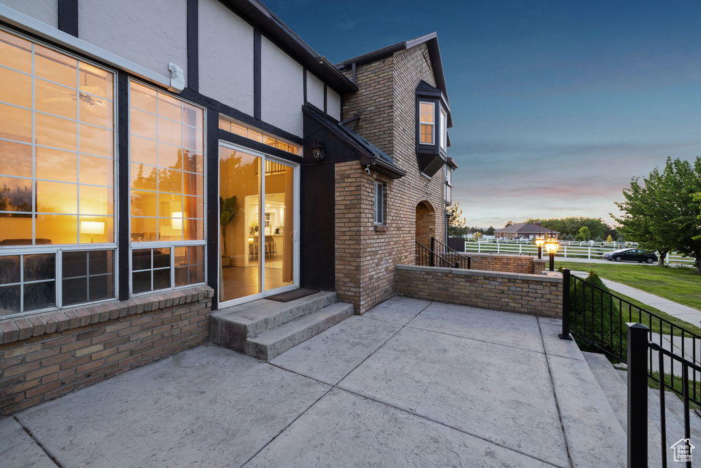 Patio terrace at dusk featuring a patio area