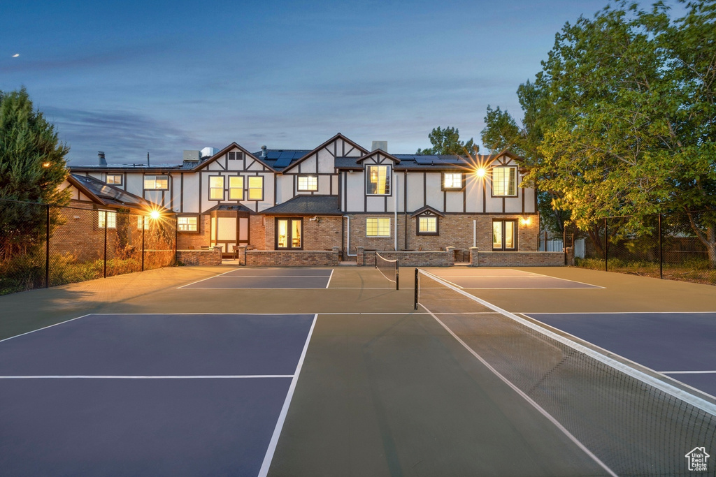 View of tennis court with basketball hoop