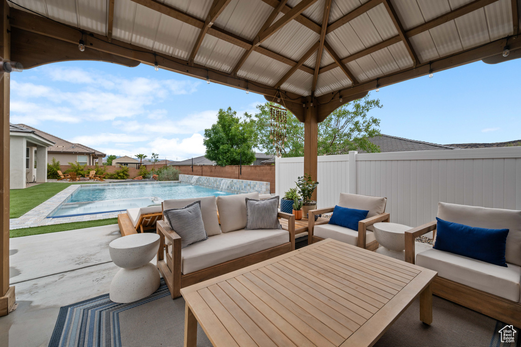 View of patio featuring outdoor lounge area, a fenced backyard, and a gazebo