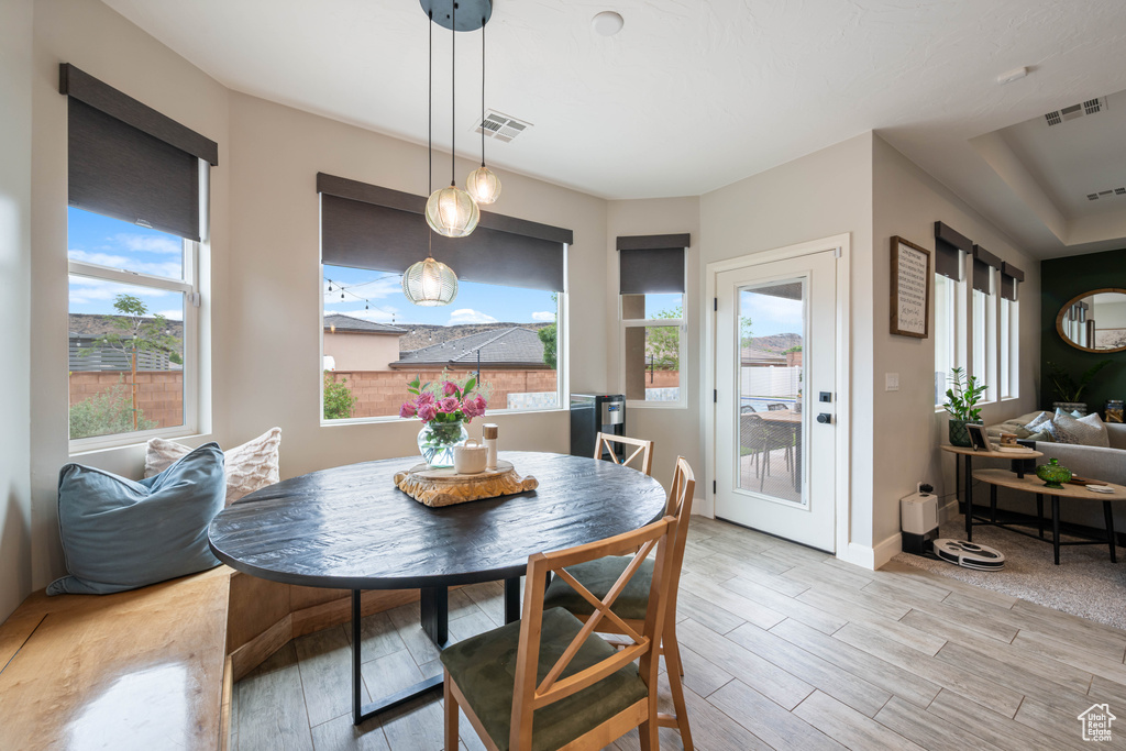 Dining space with light wood finished floors and baseboards