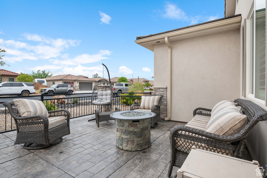 View of patio / terrace with an outdoor fire pit and a residential view