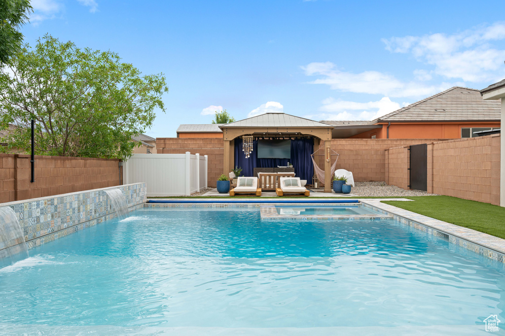 View of pool with a fenced backyard, a gazebo, and a pool with connected hot tub