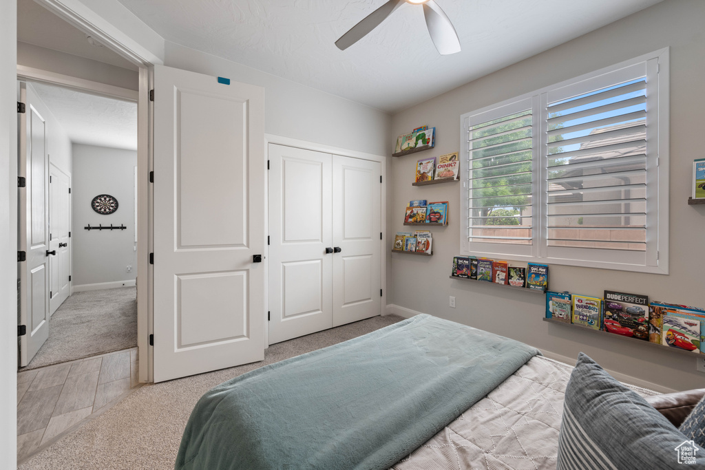 Bedroom featuring a closet, carpet floors, a ceiling fan, and baseboards