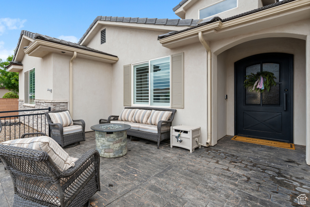 View of patio / terrace featuring an outdoor living space with a fire pit