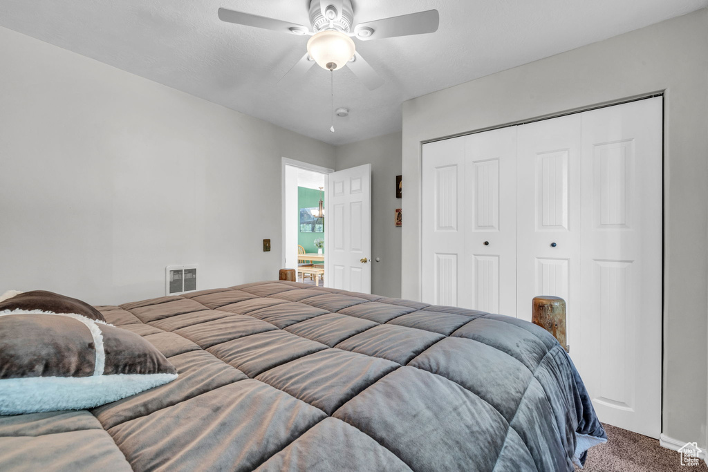 Bedroom featuring carpet flooring, a closet, and ceiling fan