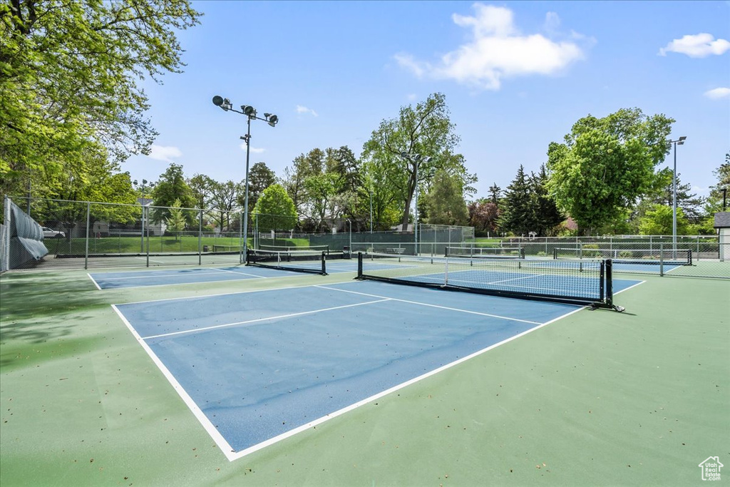 View of tennis court featuring fence