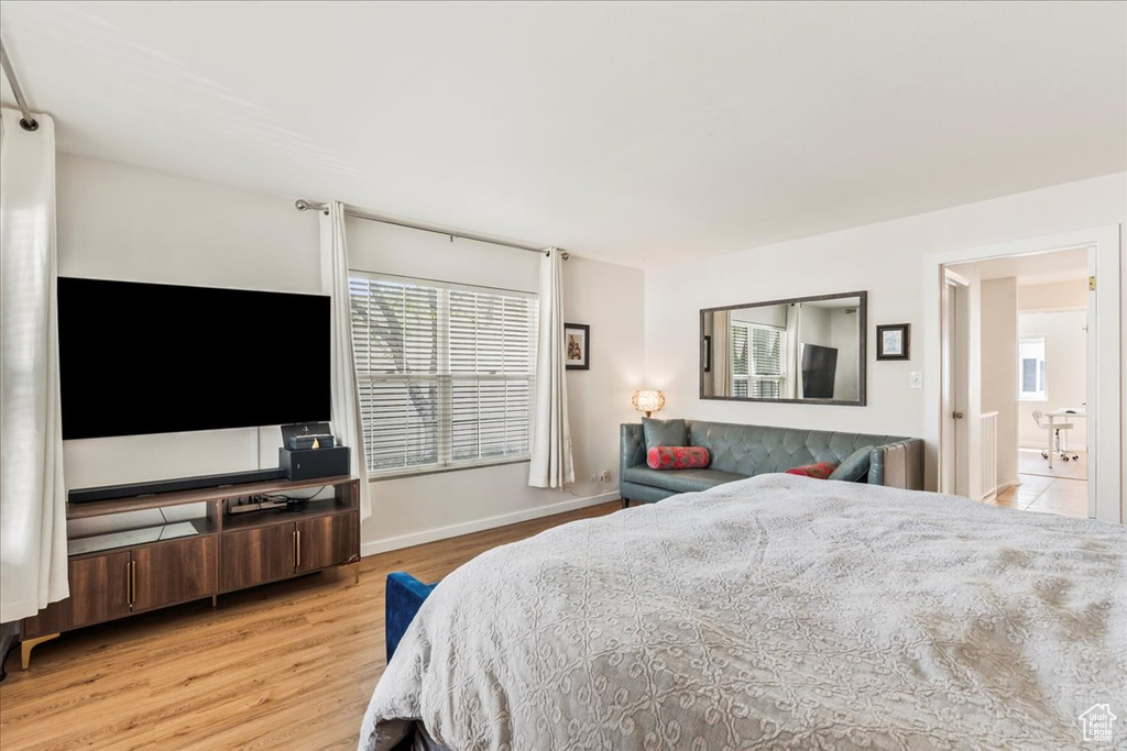 Bedroom featuring light wood-style flooring and baseboards