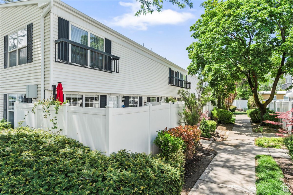 View of side of home featuring fence