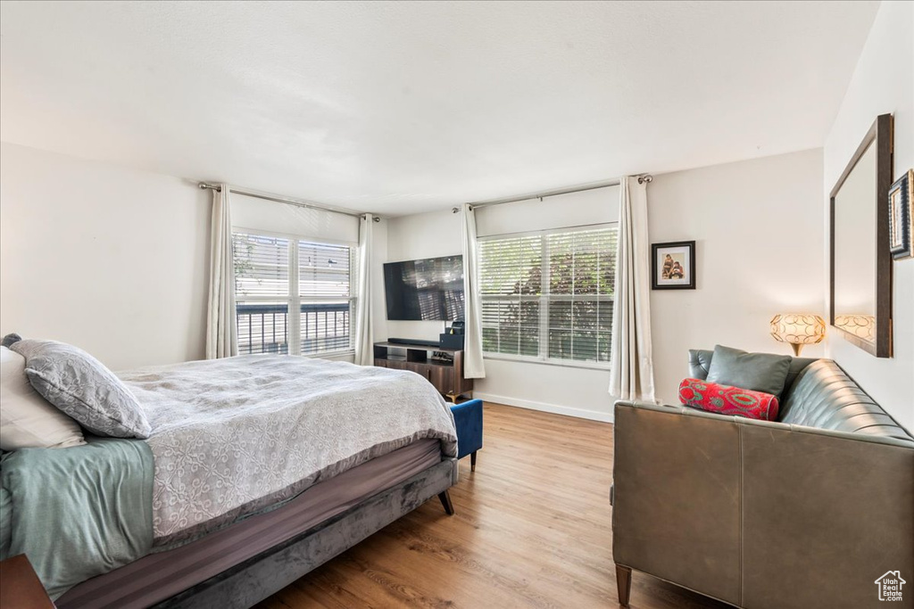 Bedroom with wood finished floors and baseboards