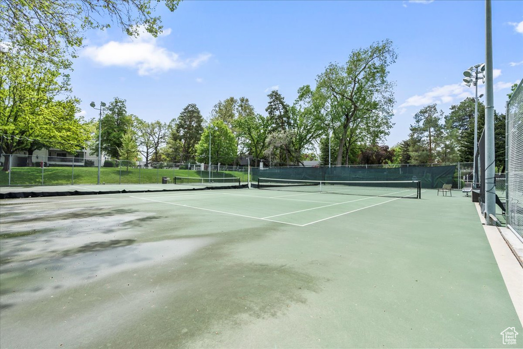 View of tennis court featuring fence