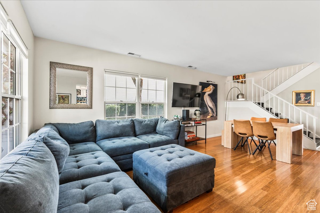 Living area with wood finished floors and stairway