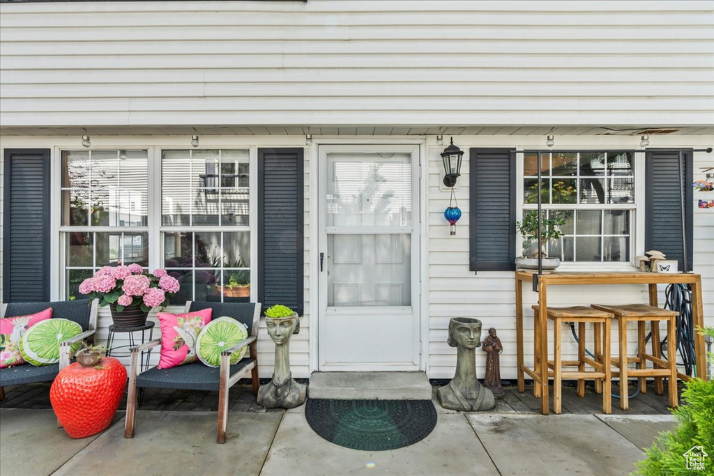 Doorway to property featuring covered porch