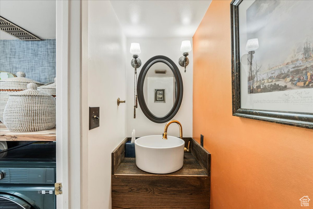 Bathroom with washer / dryer and a sink