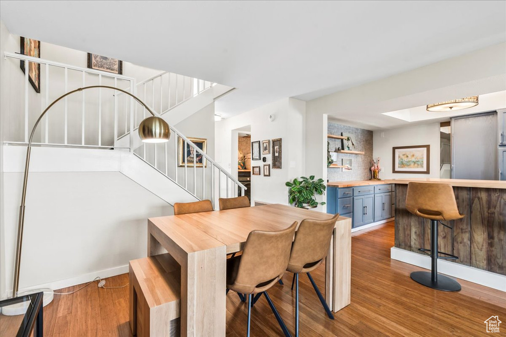 Dining room with stairs and wood finished floors