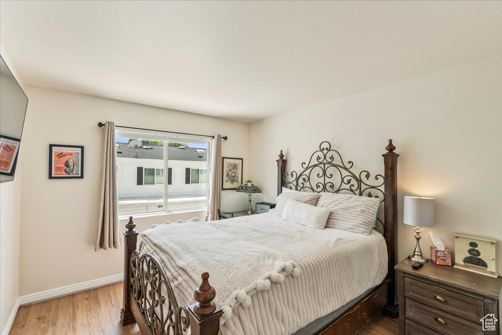 Bedroom featuring light wood-style flooring and baseboards