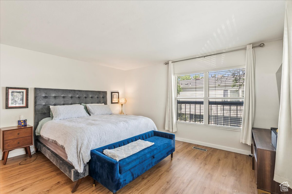 Bedroom with light wood-style flooring and baseboards