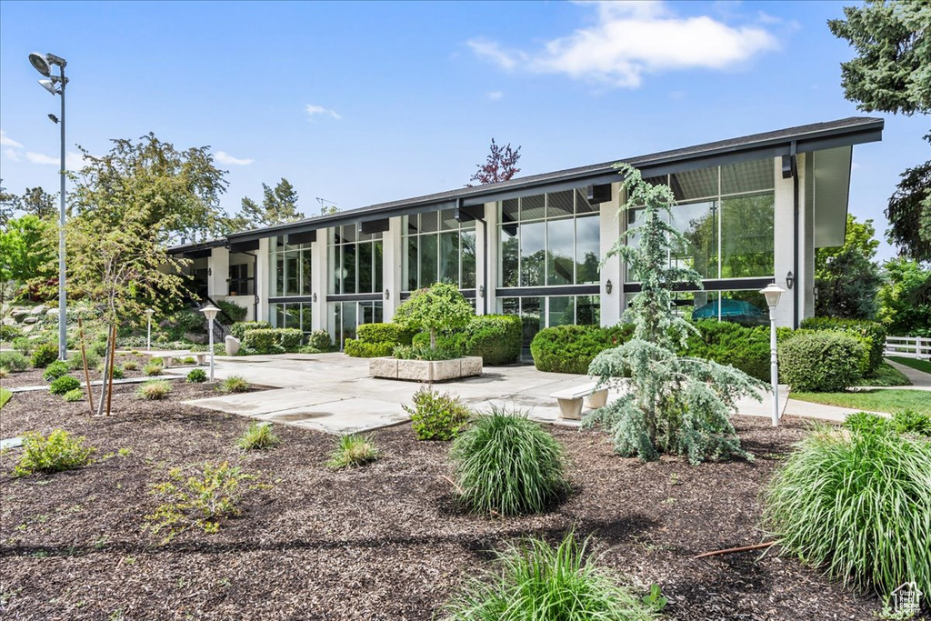 Back of house with a sunroom and a patio area
