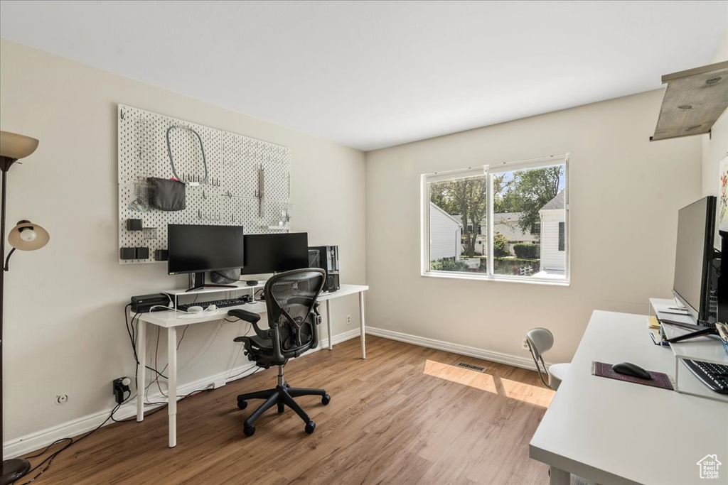 Office space with wood finished floors and baseboards