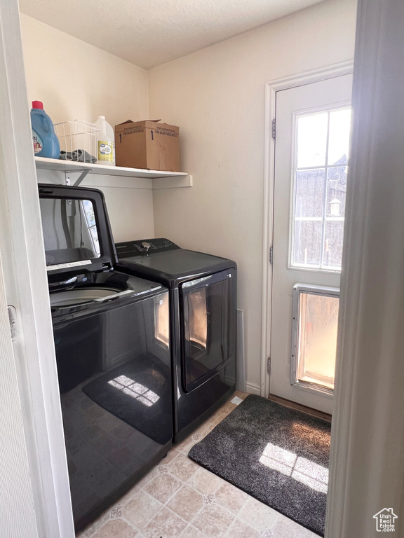 Clothes washing area featuring washer and dryer