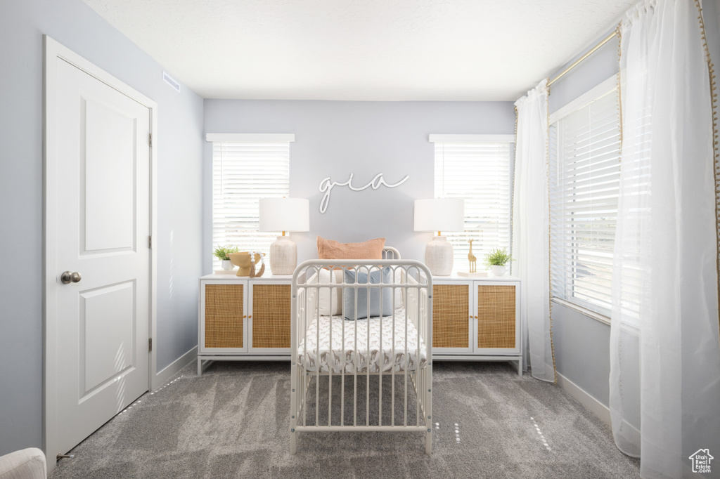 Bedroom with carpet flooring and baseboards