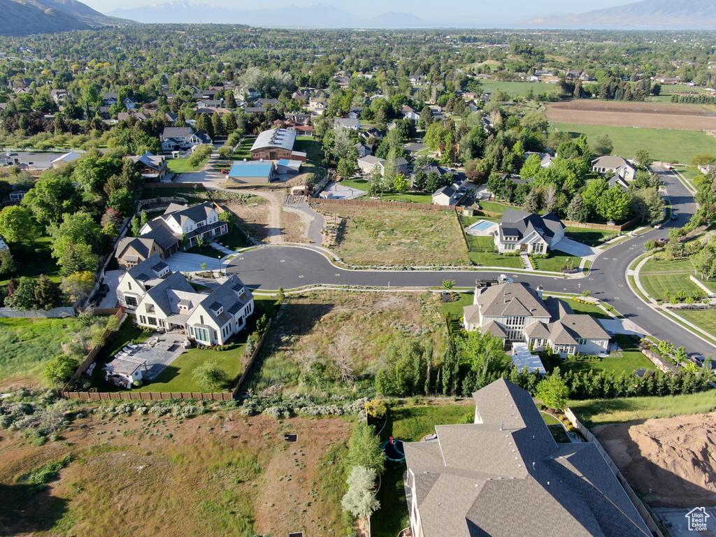 Aerial view of property's location with nearby suburban area and a mountain backdrop