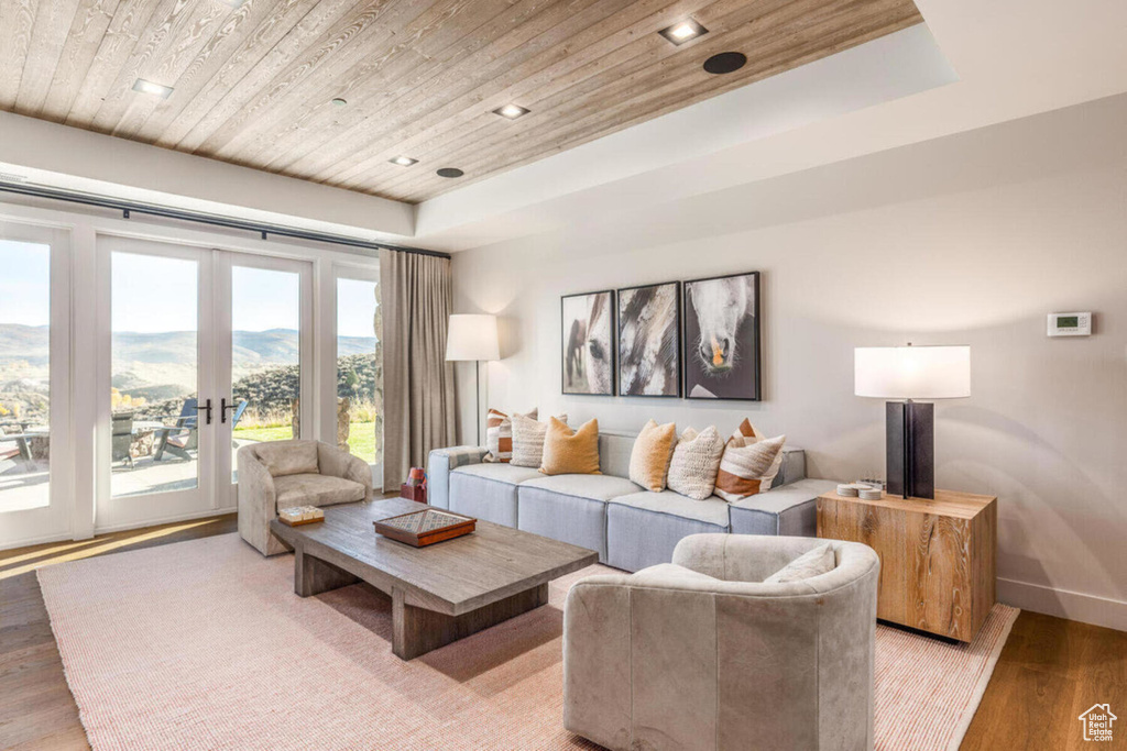 Living area featuring wood ceiling, french doors, light wood-style flooring, recessed lighting, and baseboards