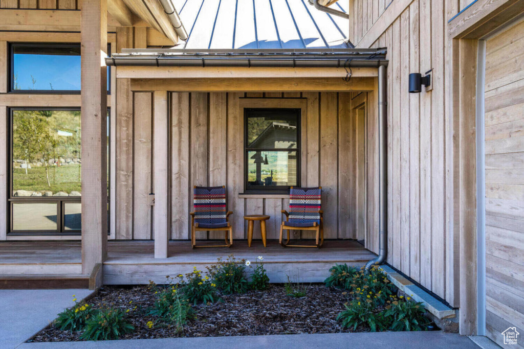 Doorway to property featuring board and batten siding and a standing seam roof