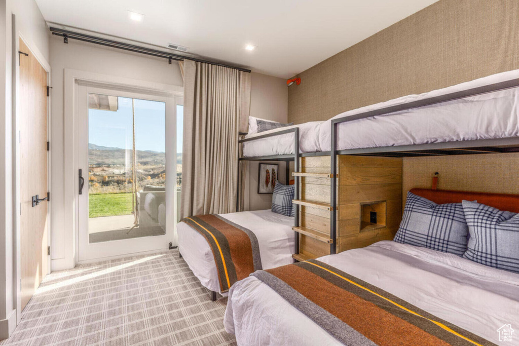 Carpeted bedroom with access to exterior and a mountain view