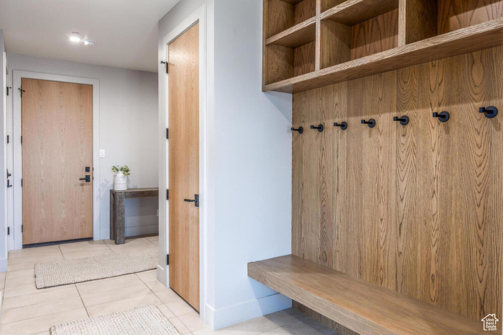 Mudroom featuring baseboards and tile patterned floors