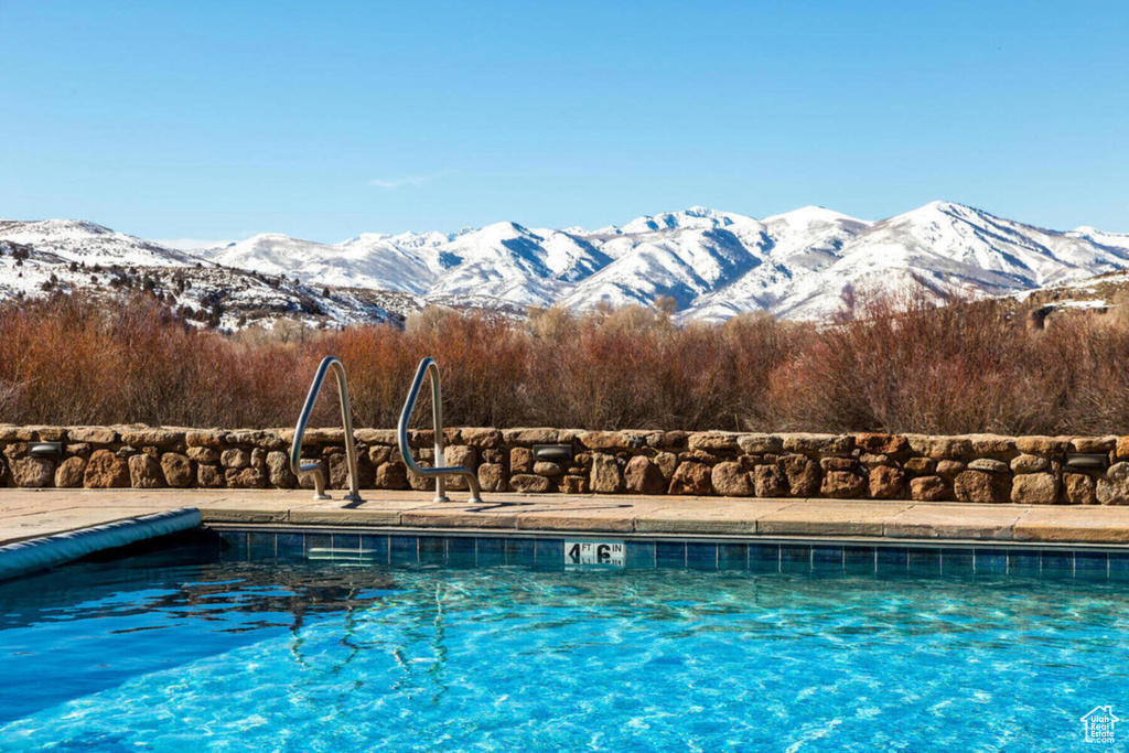 Community pool with a mountain view