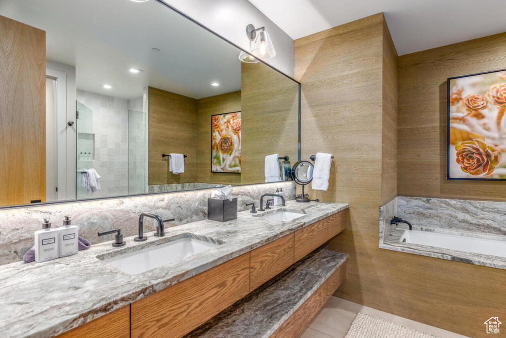 Bathroom with tile patterned flooring, double vanity, a garden tub, and recessed lighting