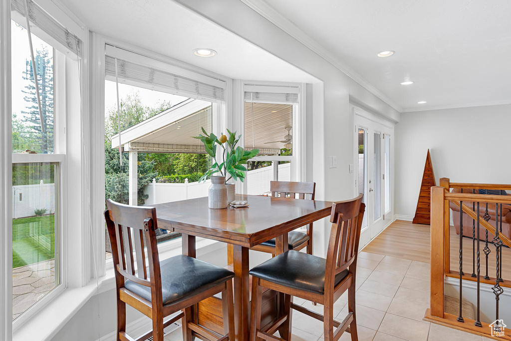 Dining space with recessed lighting, light tile patterned flooring, ornamental molding, and baseboards