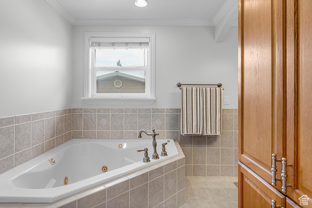 Full bathroom featuring a whirlpool tub and crown molding