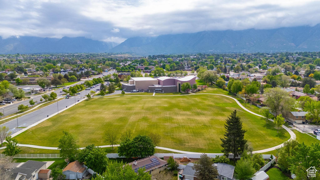 Aerial perspective of suburban area featuring a mountainous background and property boundaries highlighted