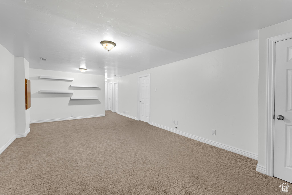 Below grade area featuring carpet floors and baseboards