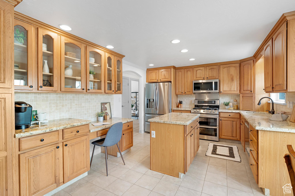 Kitchen featuring stainless steel appliances, a sink, tasteful backsplash, light stone countertops, and recessed lighting