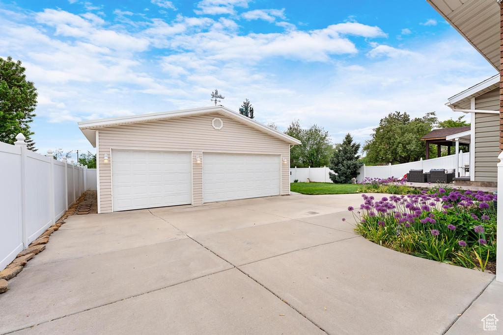 Detached garage featuring fence