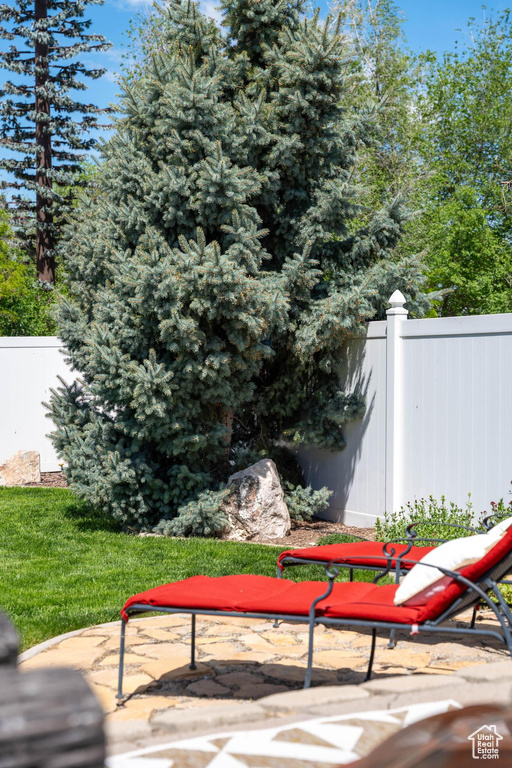 Wooden terrace featuring fence and a patio
