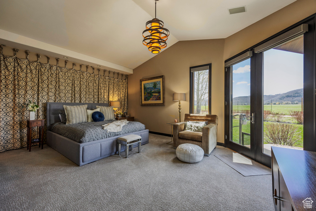 Bedroom featuring carpet floors, access to exterior, vaulted ceiling, and a mountain view