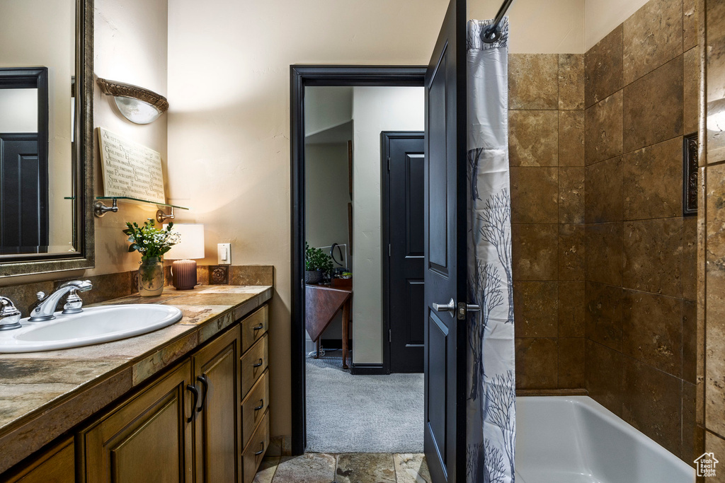 Full bath with vanity and shower / bath combination with curtain