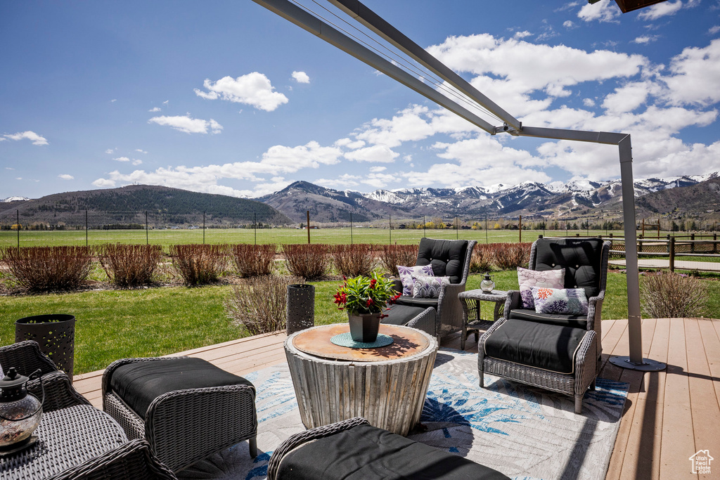 Wooden terrace with a mountain view, a rural view, and outdoor lounge area