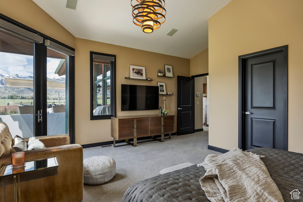 Carpeted bedroom with access to outside, vaulted ceiling, and baseboards
