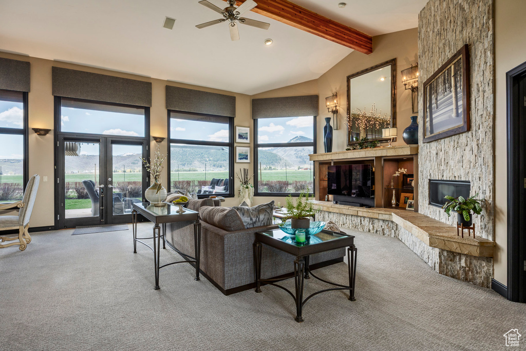 Living area featuring carpet floors, a stone fireplace, ceiling fan, french doors, and recessed lighting