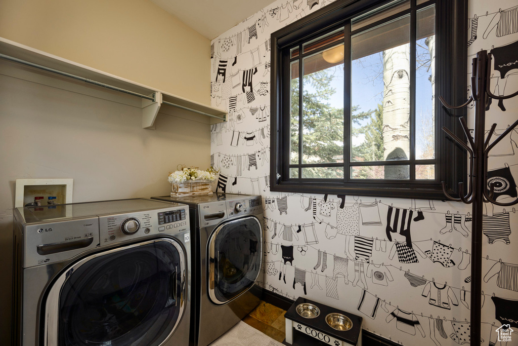Clothes washing area featuring washer and dryer