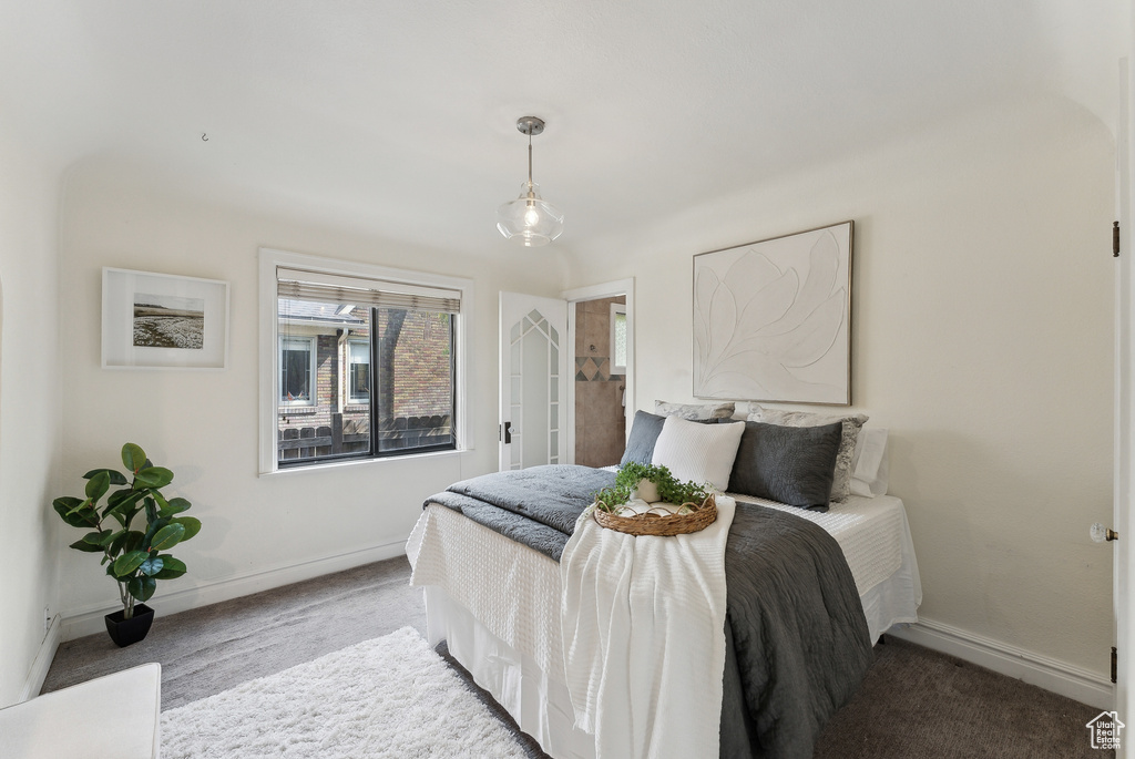 Bedroom featuring baseboards and carpet floors