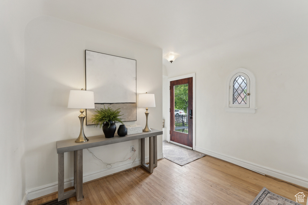 Entrance foyer with wood finished floors and baseboards