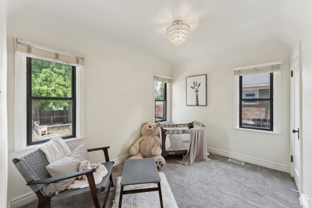 Sitting room with baseboards, a notable chandelier, carpet flooring, and visible vents